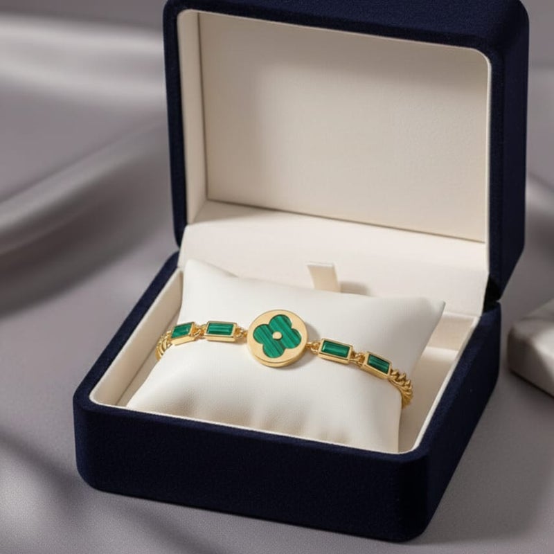 An elegant gold bracelet made of rust-resistant stainless steel, featuring a large, distinctive green flower at its center, adorned with green stones. It has an adjustable clasp for a perfect fit. - Image 5